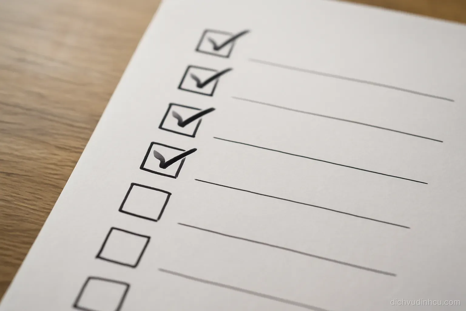 a tick box list printed on paper where half the boxes are filled and half remain empty, seen from above